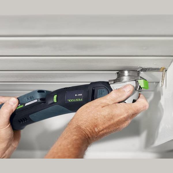 Cordless oscillating tool with Festool saw blade cutting into ceiling panel in woodworking tool accessories collection