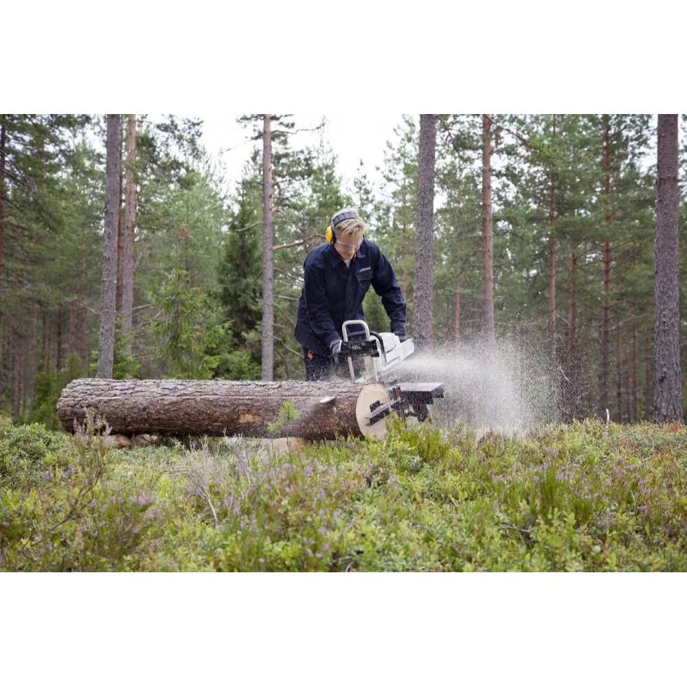 Person using portable sawmill to cut a large log outdoors in a forest setting for home improvement tasks