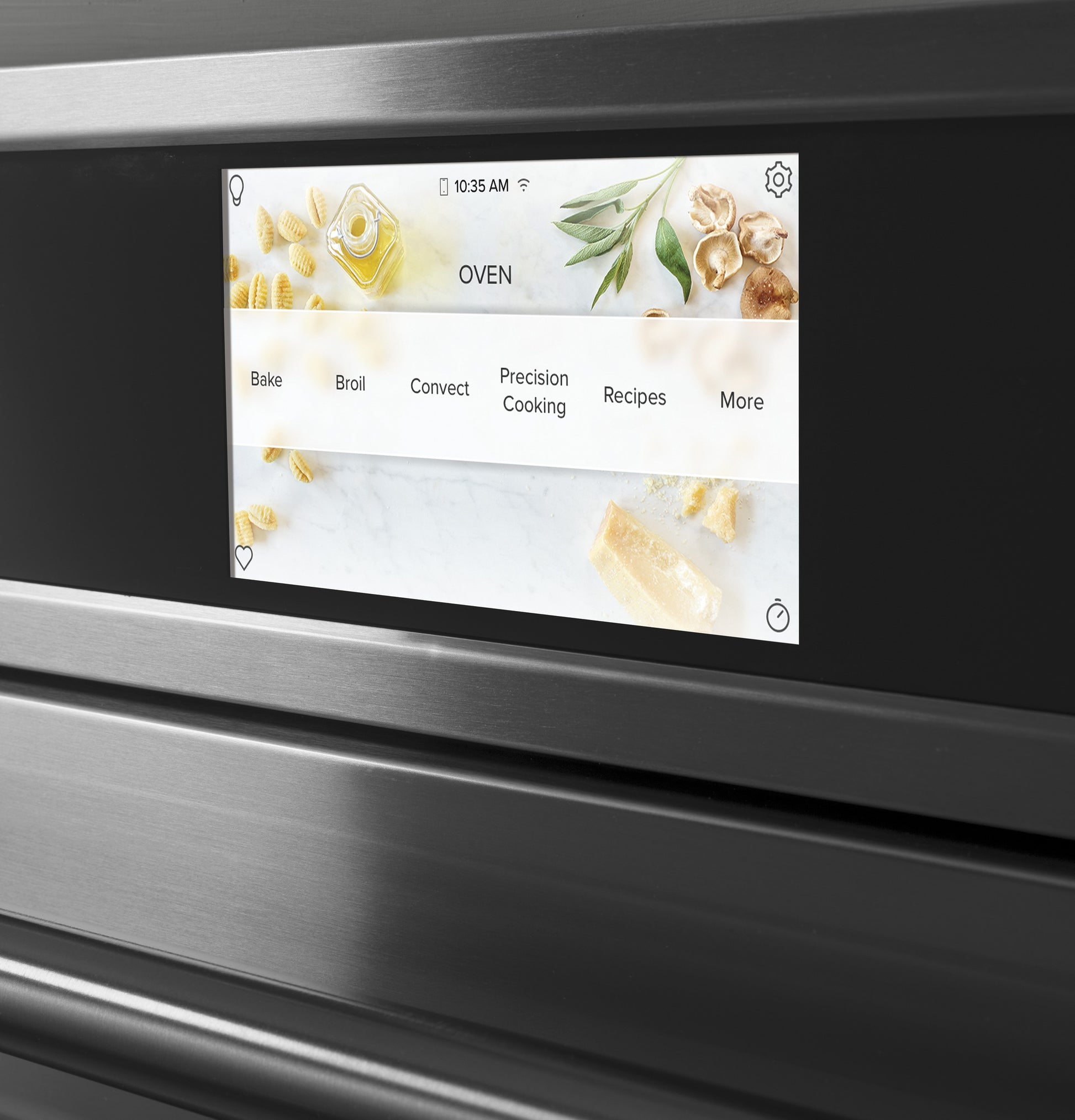 Close-up of smart wall oven touchscreen displaying cooking modes and recipe options in modern kitchen appliances setting