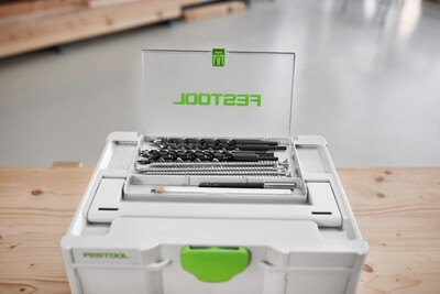 White and green Festool tool storage box with transparent lid compartment holding drill bits for workshop organization