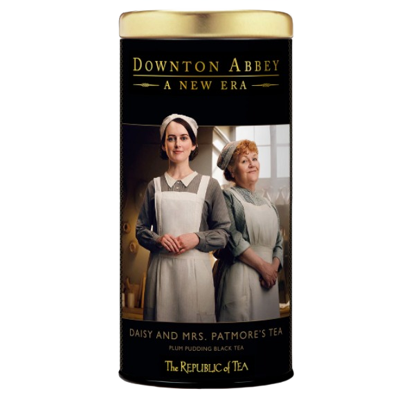 Tall tea tin featuring Downton Abbey characters Daisy and Mrs. Patmore promoting plum pudding black tea blend