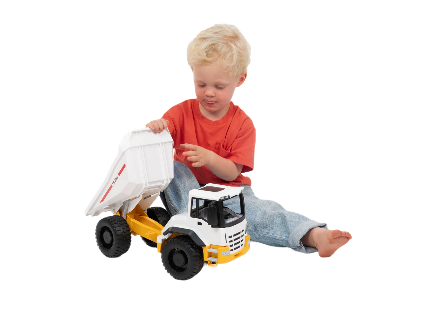 Child playing with a white and yellow Bruder dump truck toy from Vehicles & Remote Controlled Toys collection