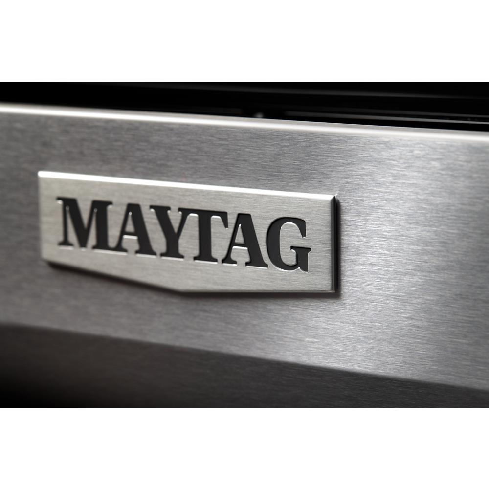 Close-up of brushed stainless steel surface featuring Maytag brand logo on an appliance in kitchen setting