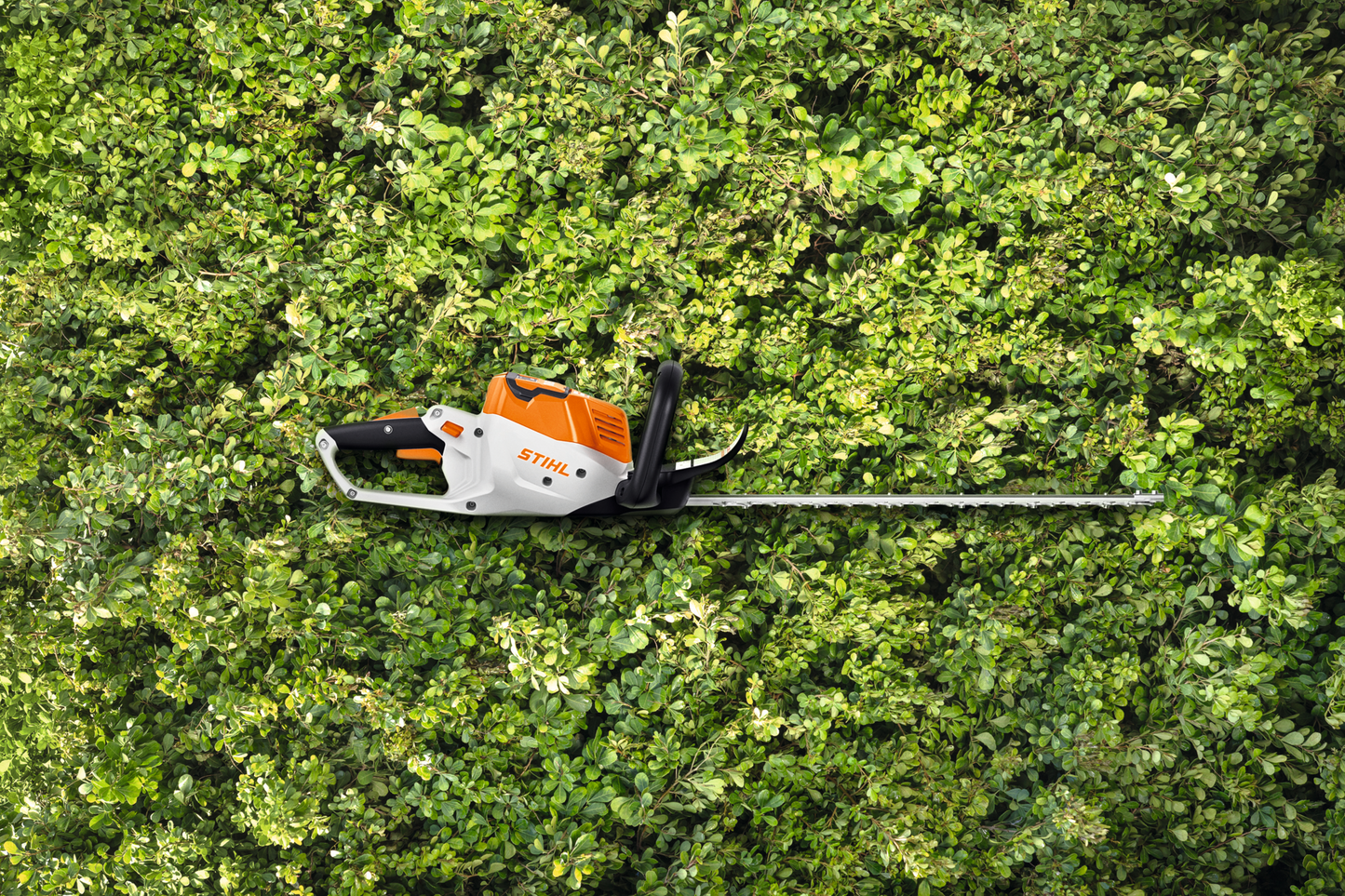 Orange and white electric hedge trimmer with 20-inch blade for precise pruning in tools and home improvement tasks