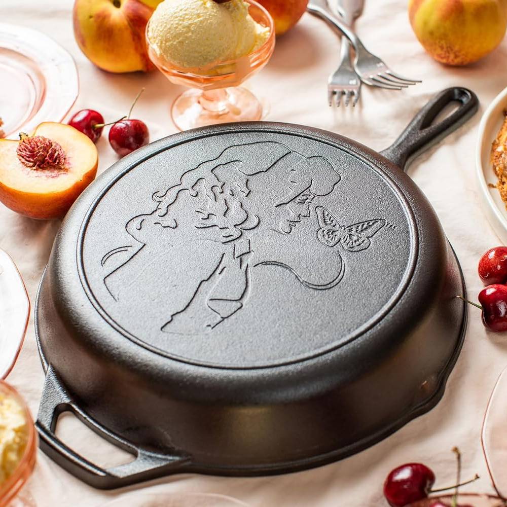 Cast iron skillet with embossed Dolly Parton profile and butterfly, part of Lodge Cast Iron Kitchenware collection under $100