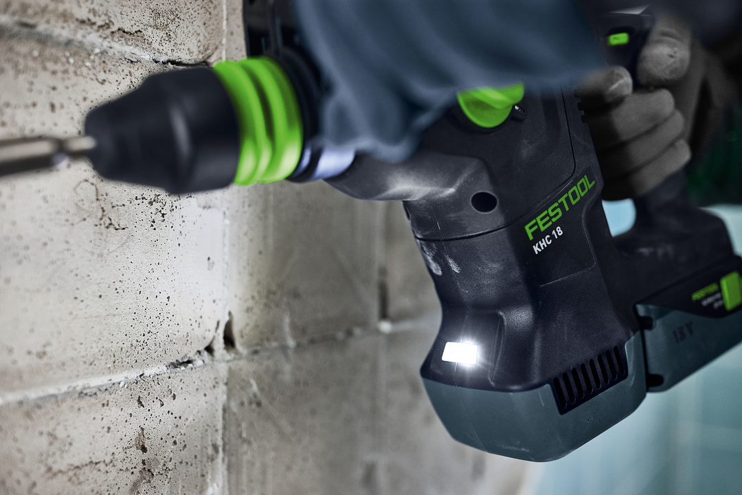 Cordless rotary hammer drill with LED light drilling into concrete for home improvement and woodworking tools collection