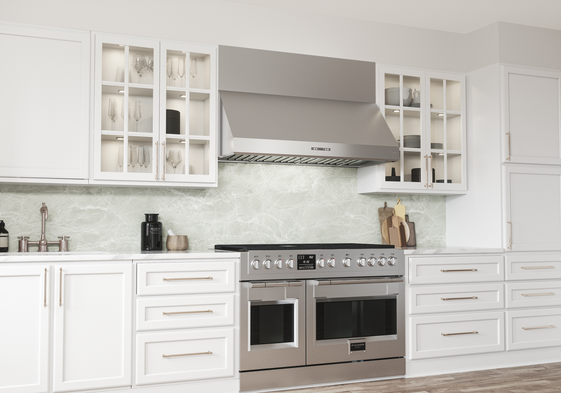 Stainless steel under cabinet range hood above double oven stove in modern kitchen with white cabinetry and marble backsplash