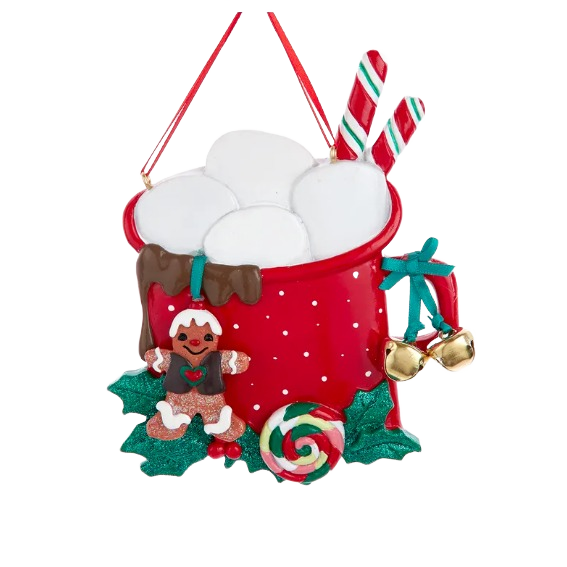 Red holiday ornament shaped like a mug with marshmallows, candy canes, gingerbread figure, and festive decorations