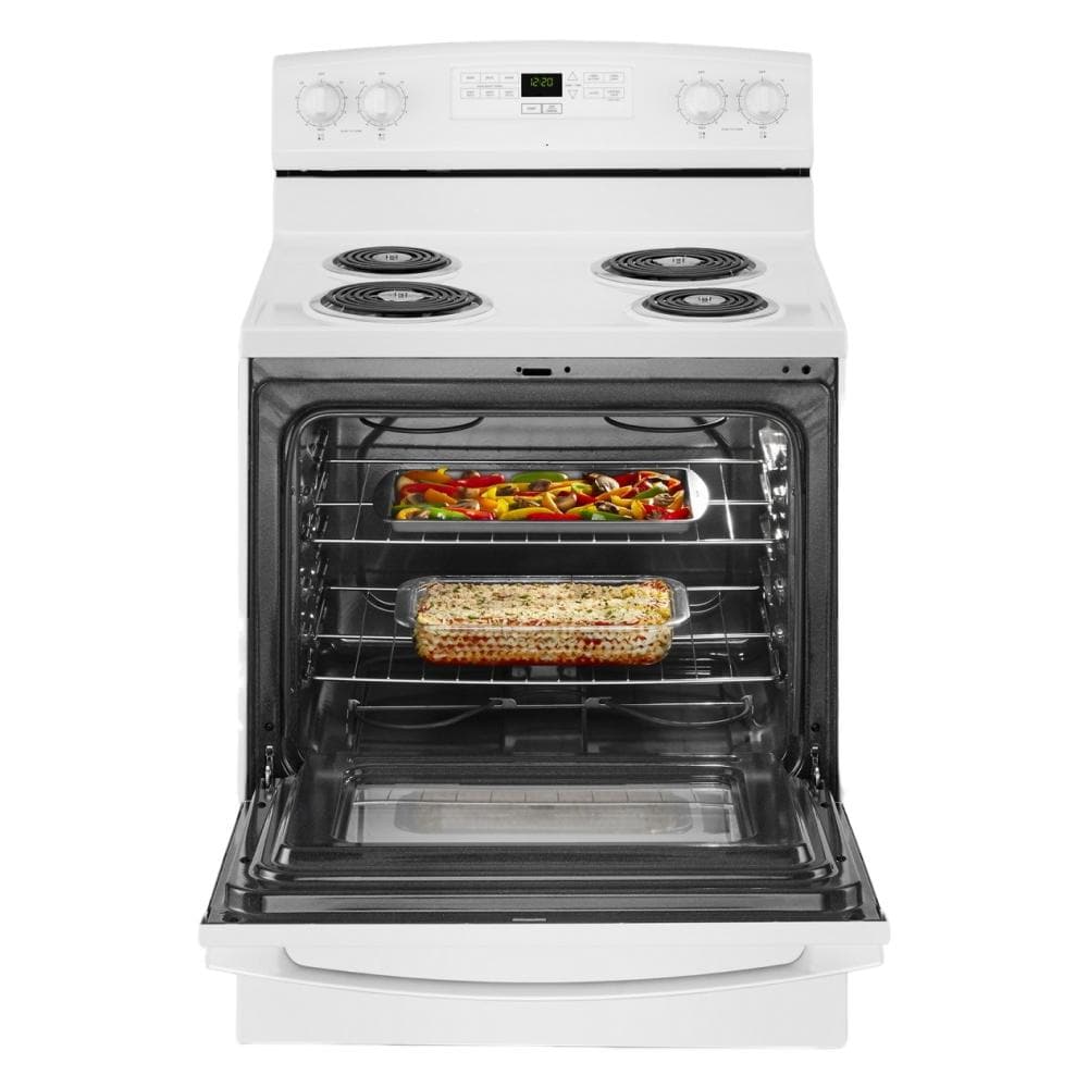 Open white electric range with bake assist temps showing cooked casserole and roasted vegetables inside oven cavity