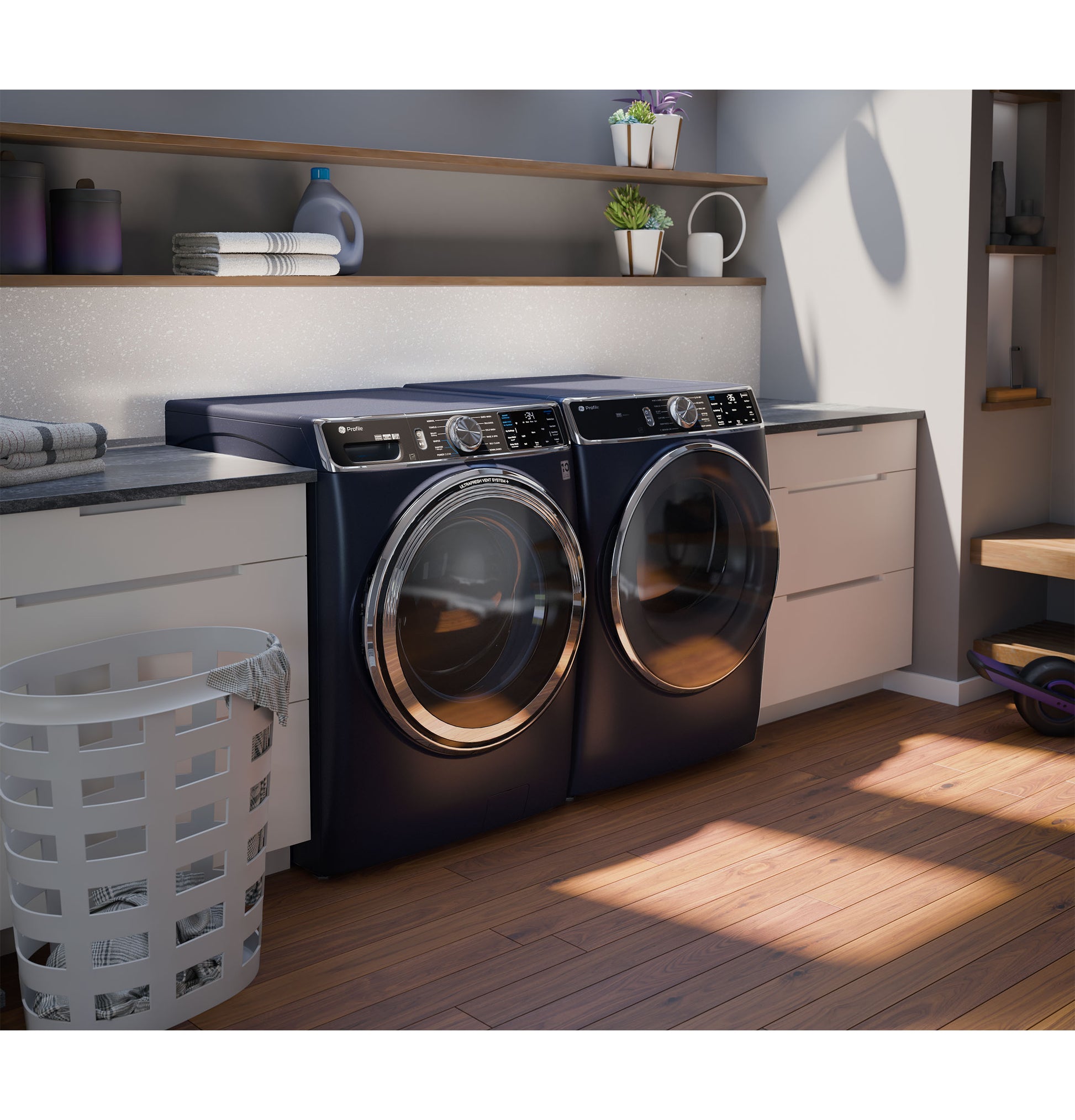 Dark blue smart front load washer and dryer set with digital controls in a modern laundry room with wood flooring and shelves
