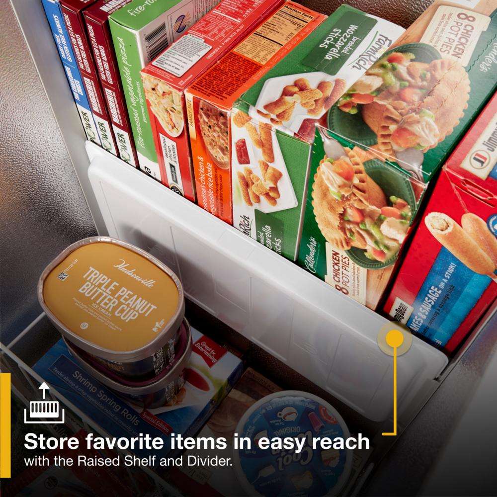 Close-up of freezer compartment showing raised shelf and divider organizing frozen meals and ice cream from Freezers collection