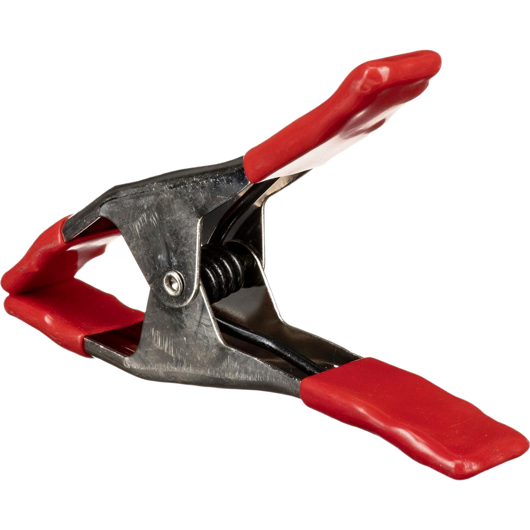 Steel spring clamp with red non-slip grips designed for secure holding during home improvement tasks