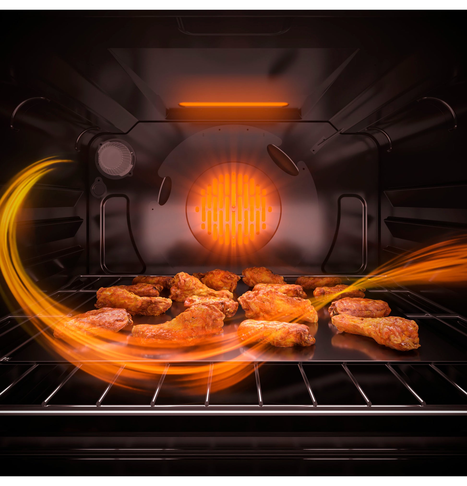 Convection oven interior with chicken wings cooking and visible heat circulation within stainless steel walls