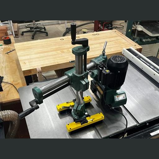 Metal power feeder with green and yellow switchable magnetic mount on a saw table in tool accessory setup