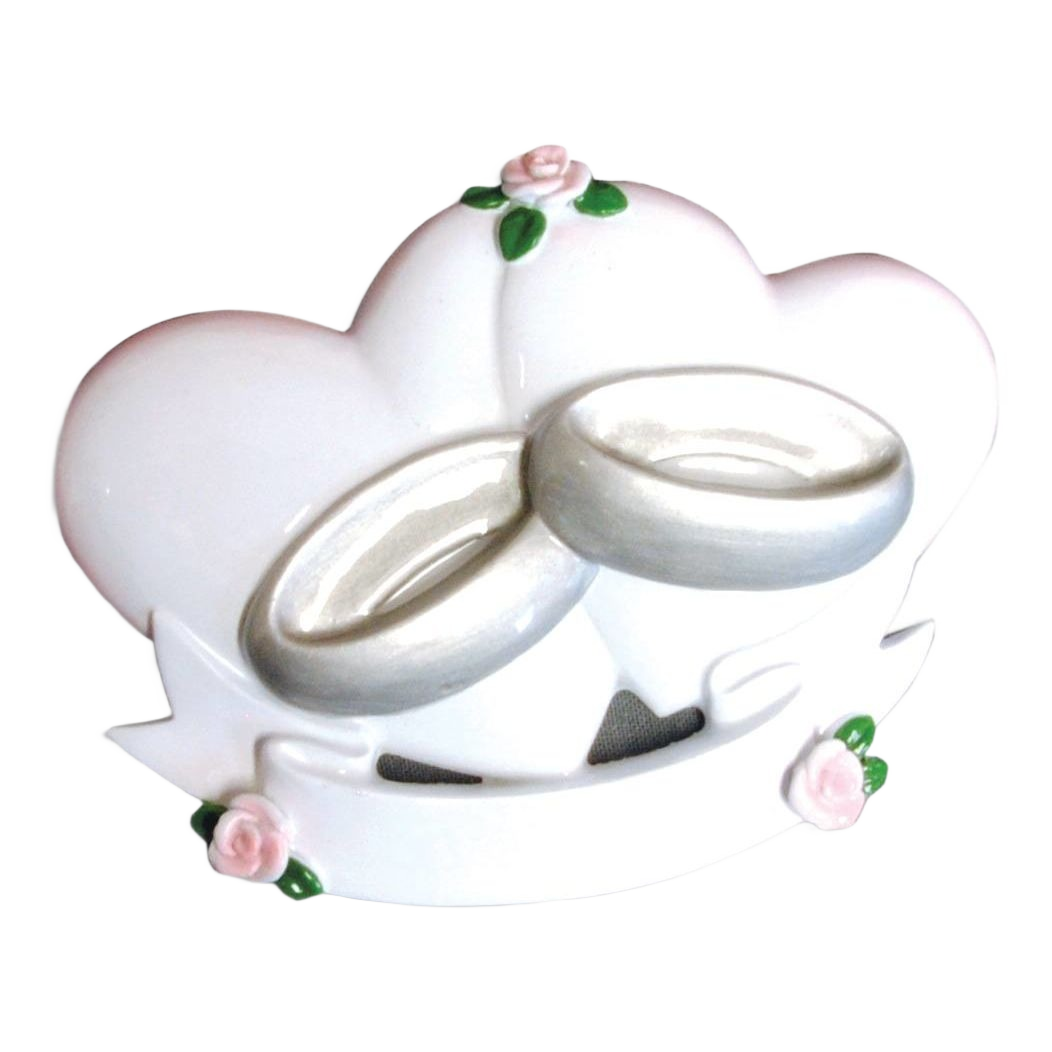 White heart-shaped ornament featuring two silver wedding rings with pink rose accents from Christmas collection