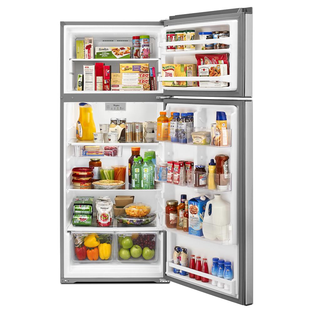 Open top-freezer refrigerator filled with various beverages, packaged foods, fresh fruits, and vegetables inside kitchen appliance collection