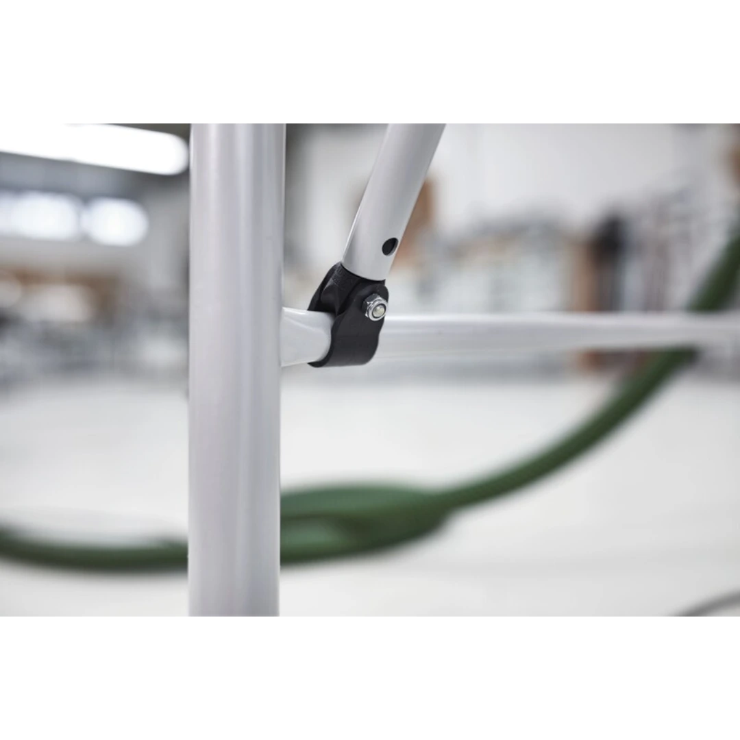 Close-up of a white metal cross member joint with bolt for reinforcing woodworking multifunction table accessories