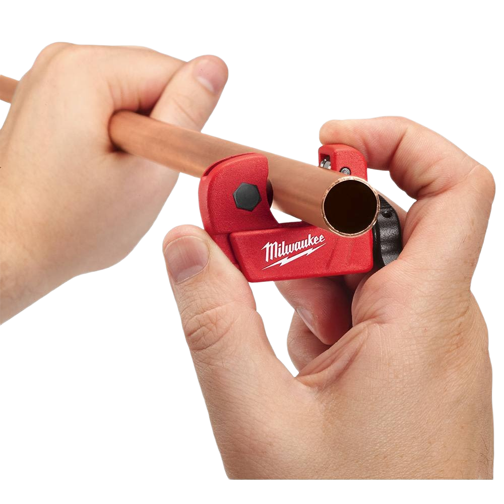 Hands using a red Milwaukee tubing cutter to trim 1/2 inch copper pipe for home improvement tasks