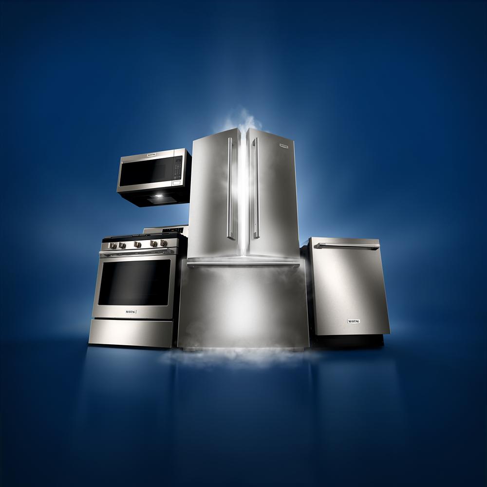 Stainless steel kitchen appliances set including refrigerator, range, microwave, and dishwasher in home improvement collection