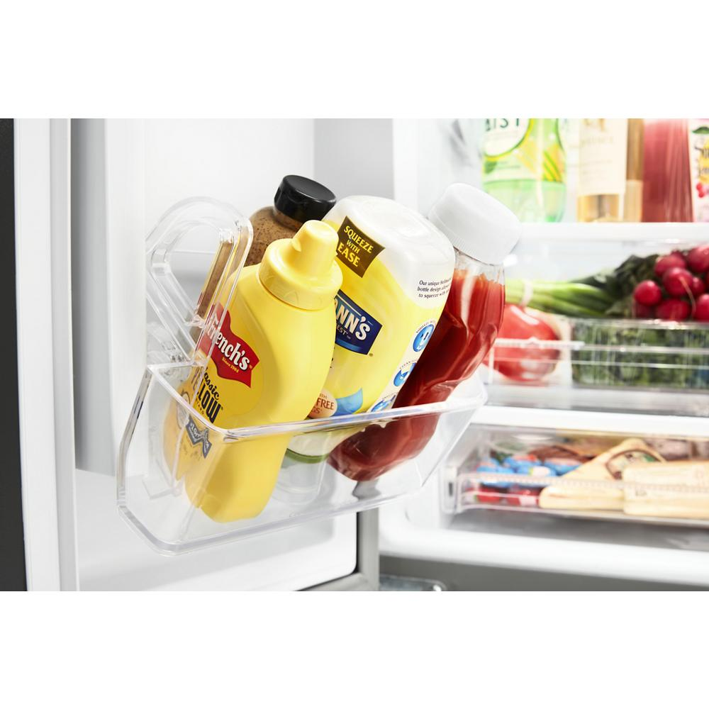 Clear door bin with mustard, mayonnaise, ketchup, and spices inside a French door refrigerator interior from Appliances collection