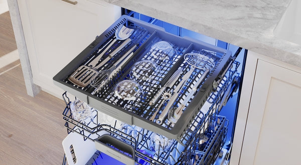 Fully extended dishwasher utensil rack with stainless steel cutlery and kitchen tools in modern kitchen setting