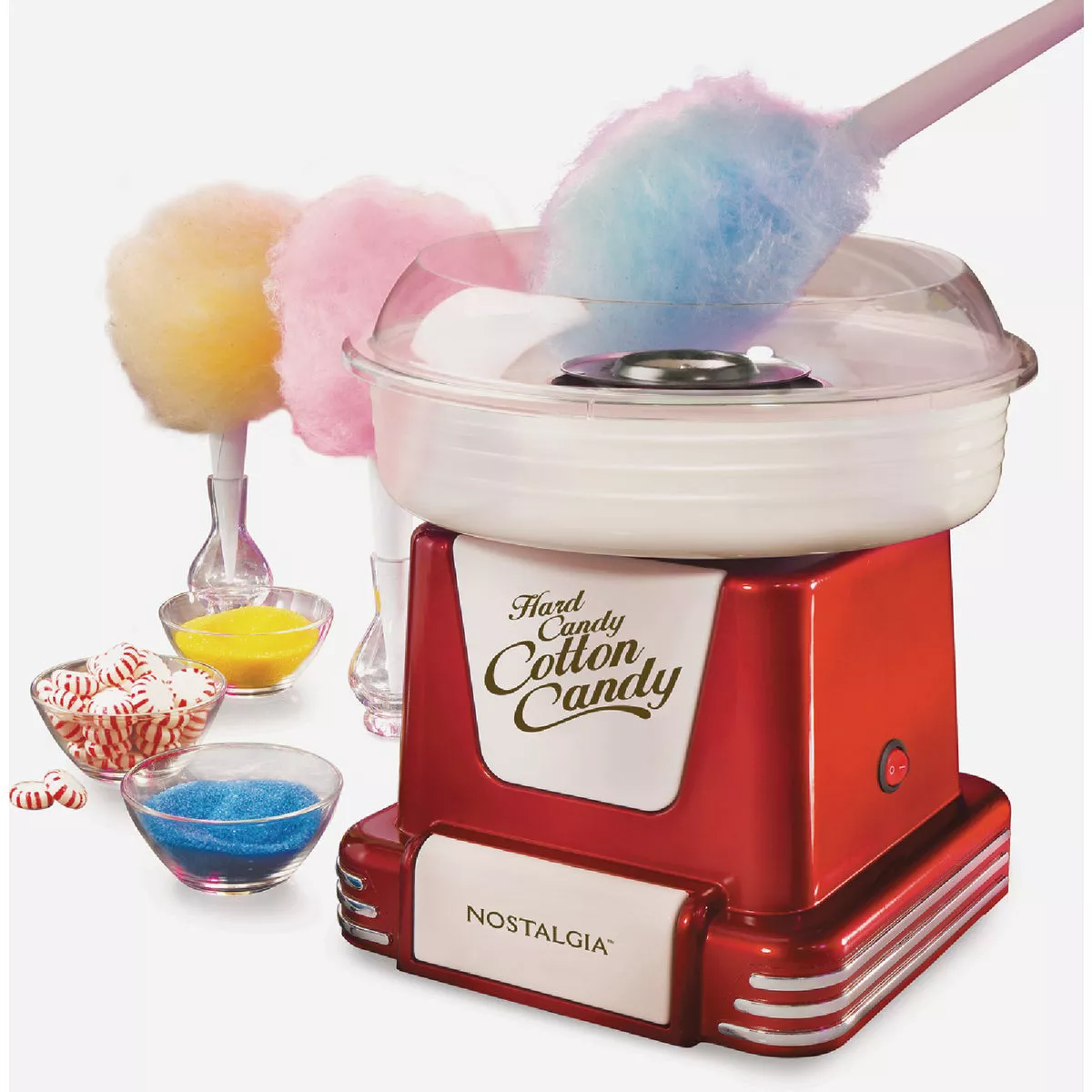 Retro red cotton candy maker with three pastel-colored cotton candy cones and small glass bowls of candy sugar nearby