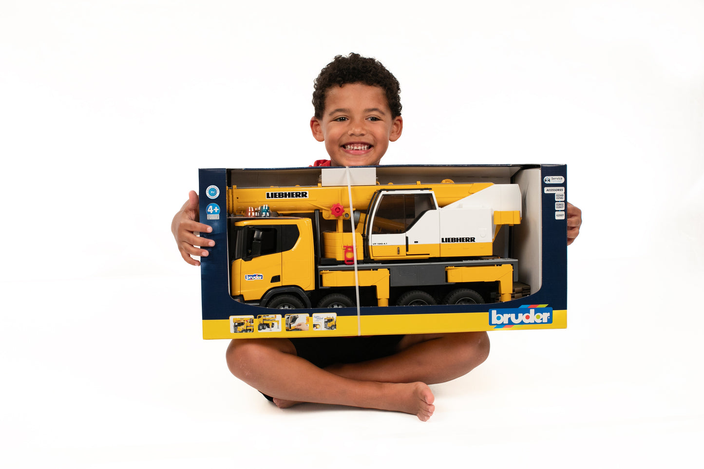 Child holding Bruder Scania crane truck toy with detailed cabin and fold-out boom in Toys & Games collection