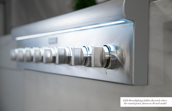 Close-up of stainless steel cooktop control knobs with LED downlighting for kitchen and home improvement use