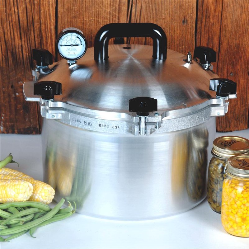 Heavy-duty aluminum pressure canner with black handle, pressure gauge, and secure locking clamps in kitchenware collections