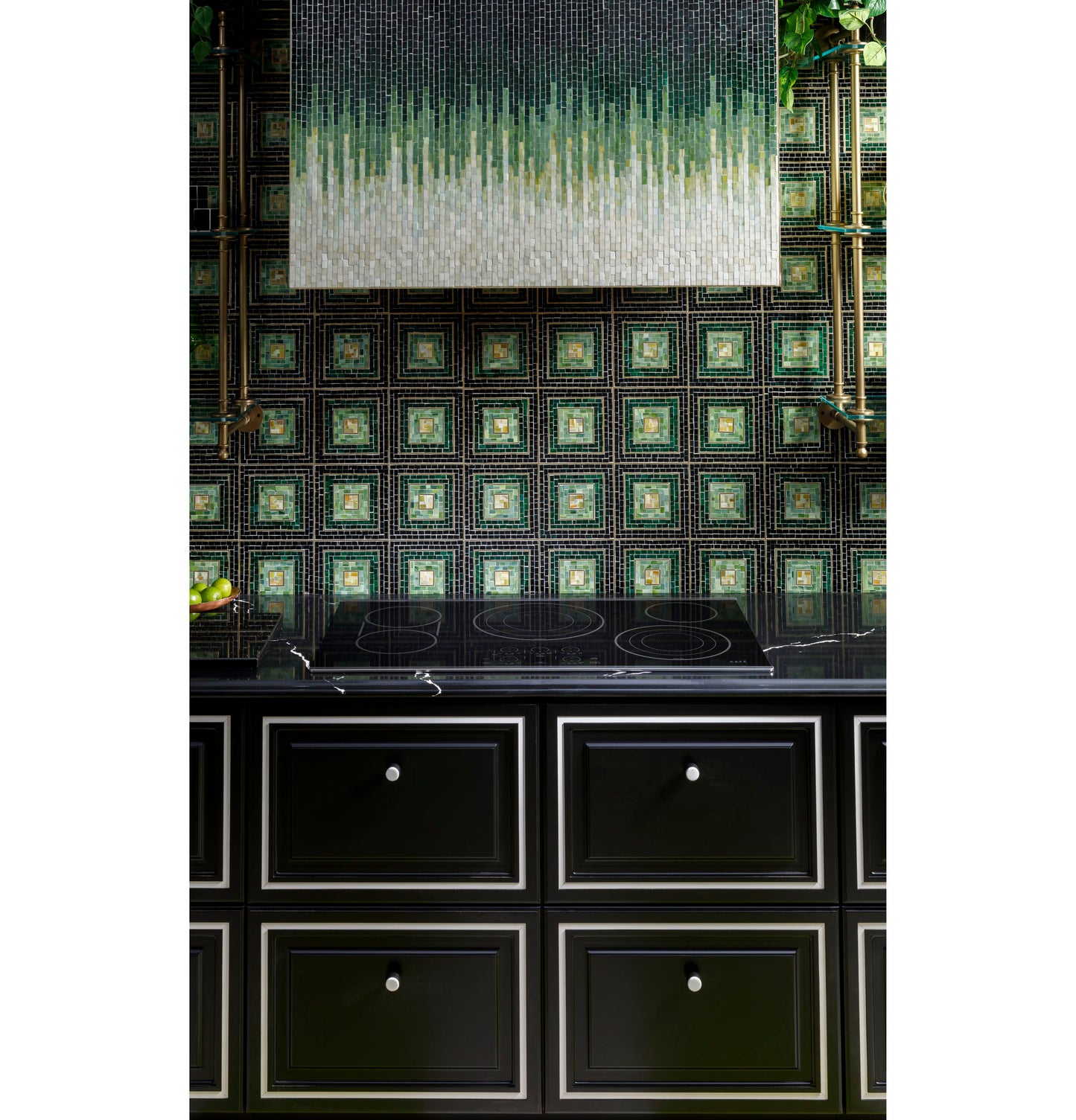 Black 36-inch touch-control electric cooktop installed on black cabinetry with decorative green tile backsplash in kitchen