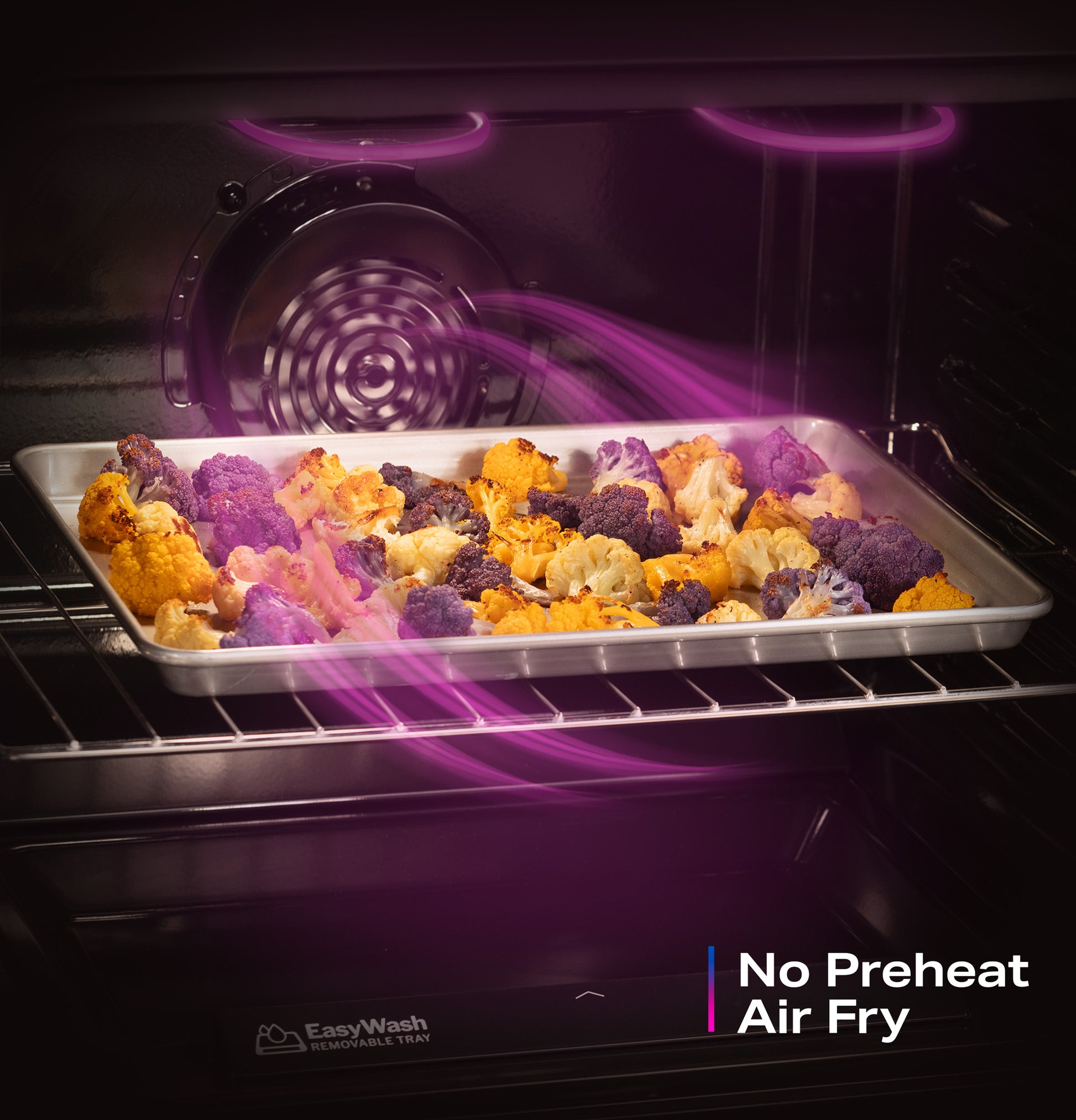 Oven roasting colorful cauliflower on an EasyWash™ tray with visible convection airflow inside a gas range