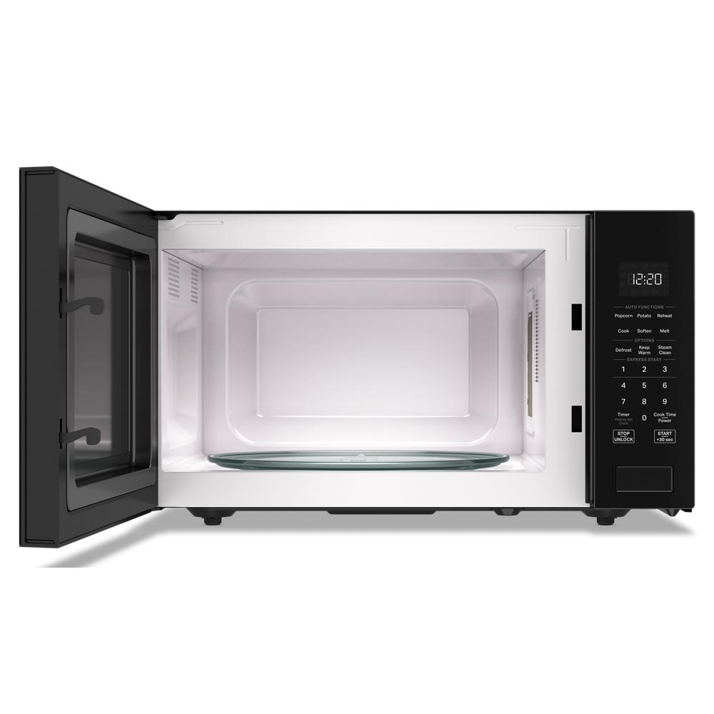 Open black Whirlpool microwave with 1.6 cu. ft. capacity, sensor cooking, and digital control panel from Microwaves collection