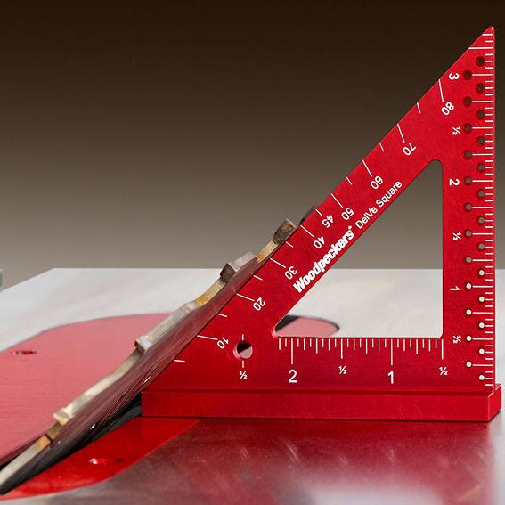Red 3.5-inch aircraft-grade aluminum woodworking square on table saw for precise layout in hand tools collection