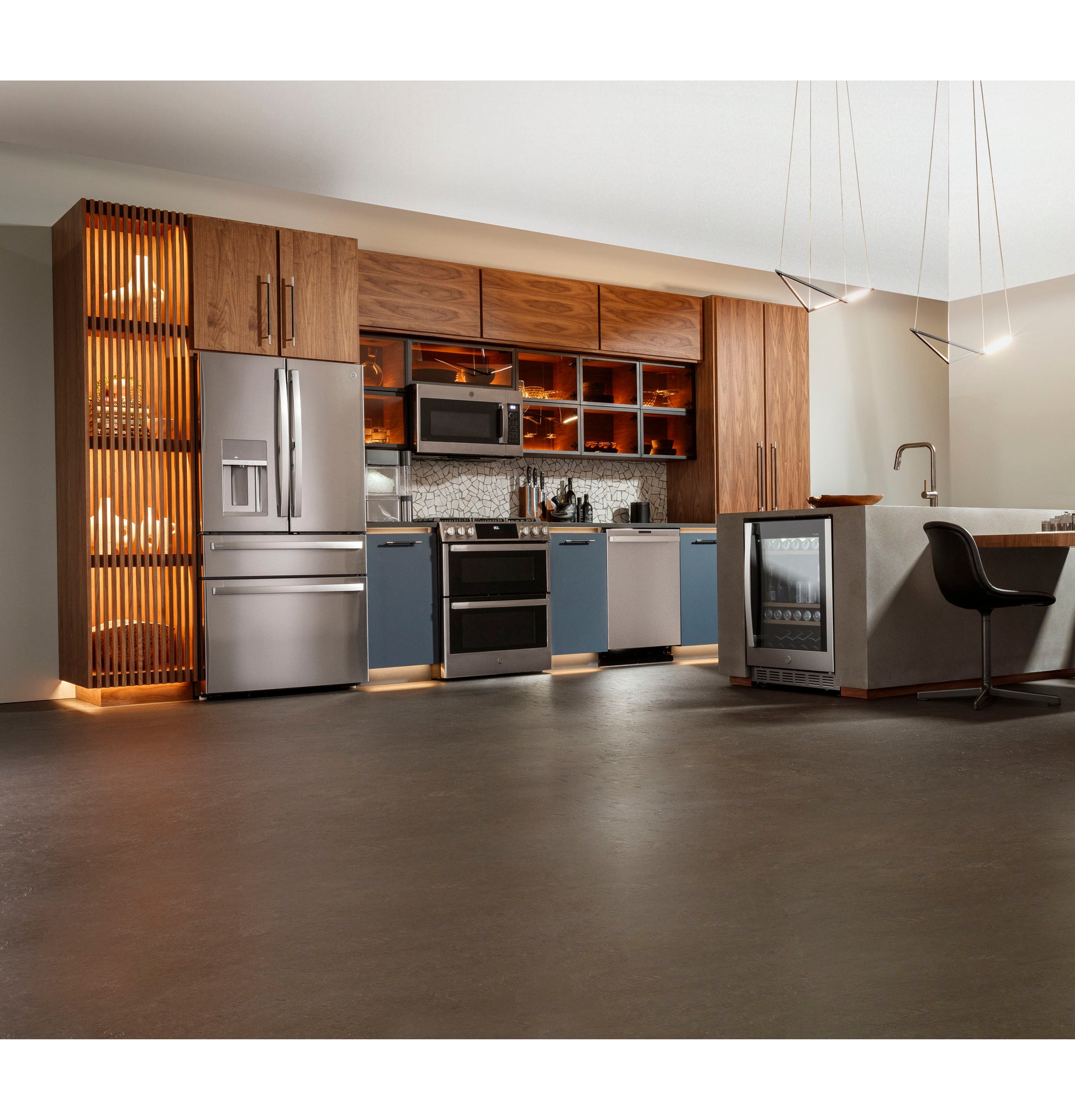 Contemporary kitchen with stainless steel refrigerator, slide-in gas range, dishwasher, and wine cooler in wood and blue cabinetry setting