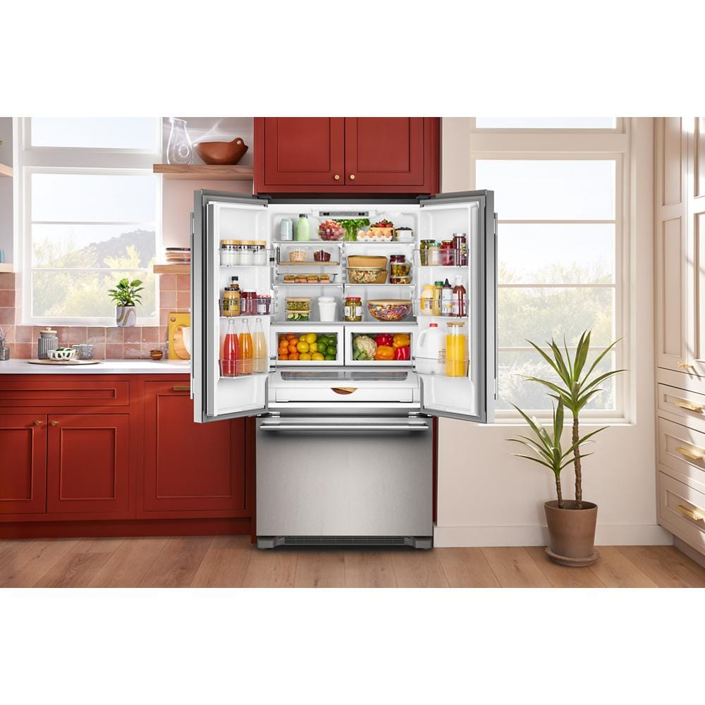 Open stainless steel French door refrigerator filled with fresh fruits, vegetables, and beverages in a modern kitchen setting