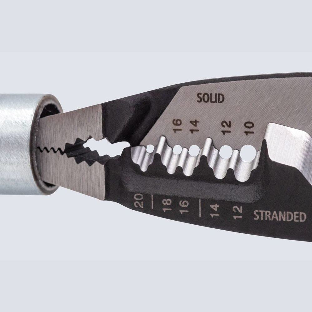 Close-up of forged wire strippers cutting a silver metal tube with precision for home improvement tasks