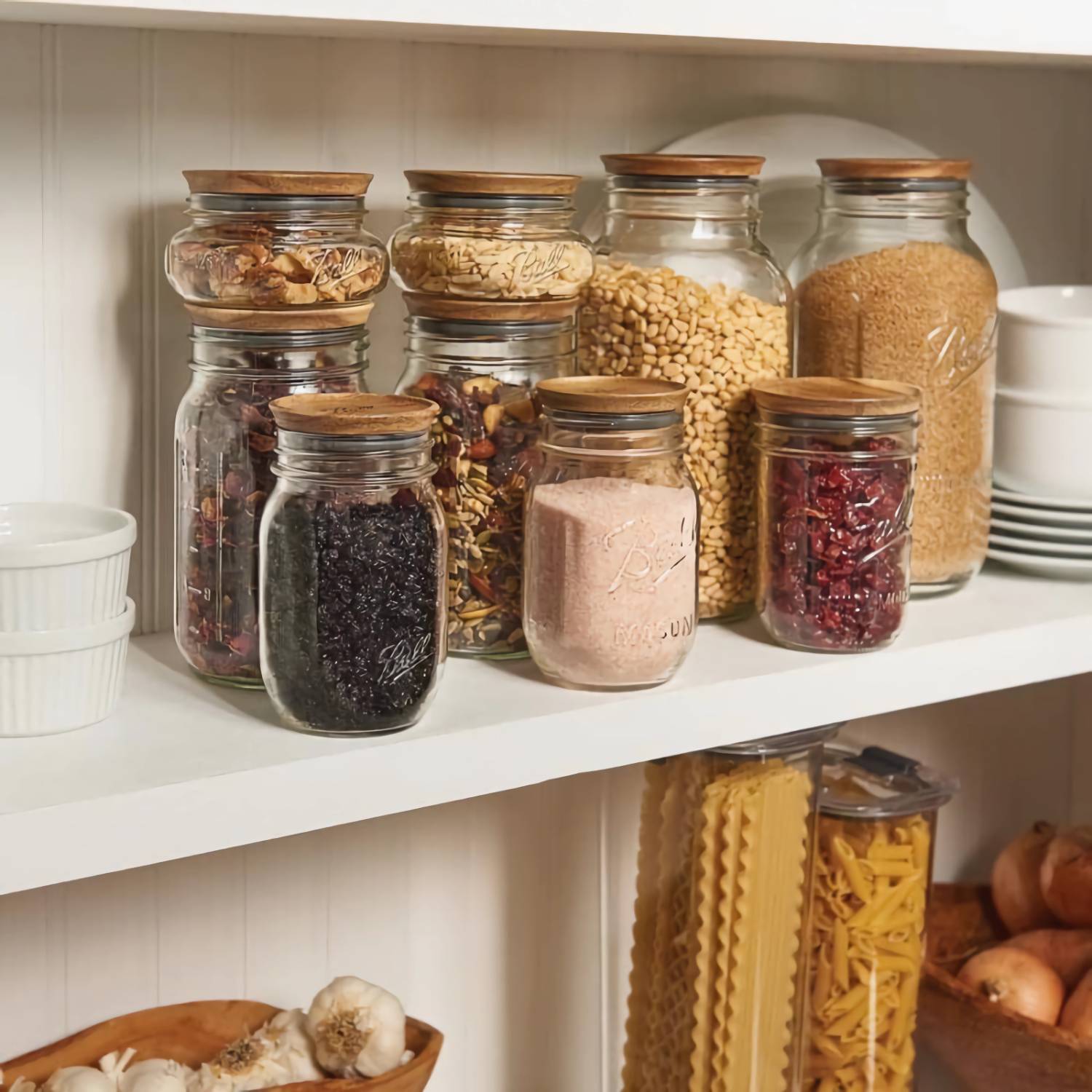 Clear glass jars with wooden lids storing various dry goods on a kitchenware shelf under $50 collection