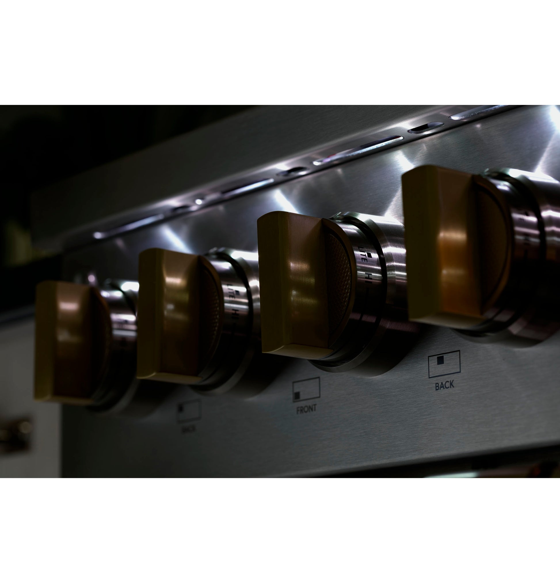 Close-up of stainless steel cooktop control knobs with illuminated panel in kitchen appliance and cooktops collections