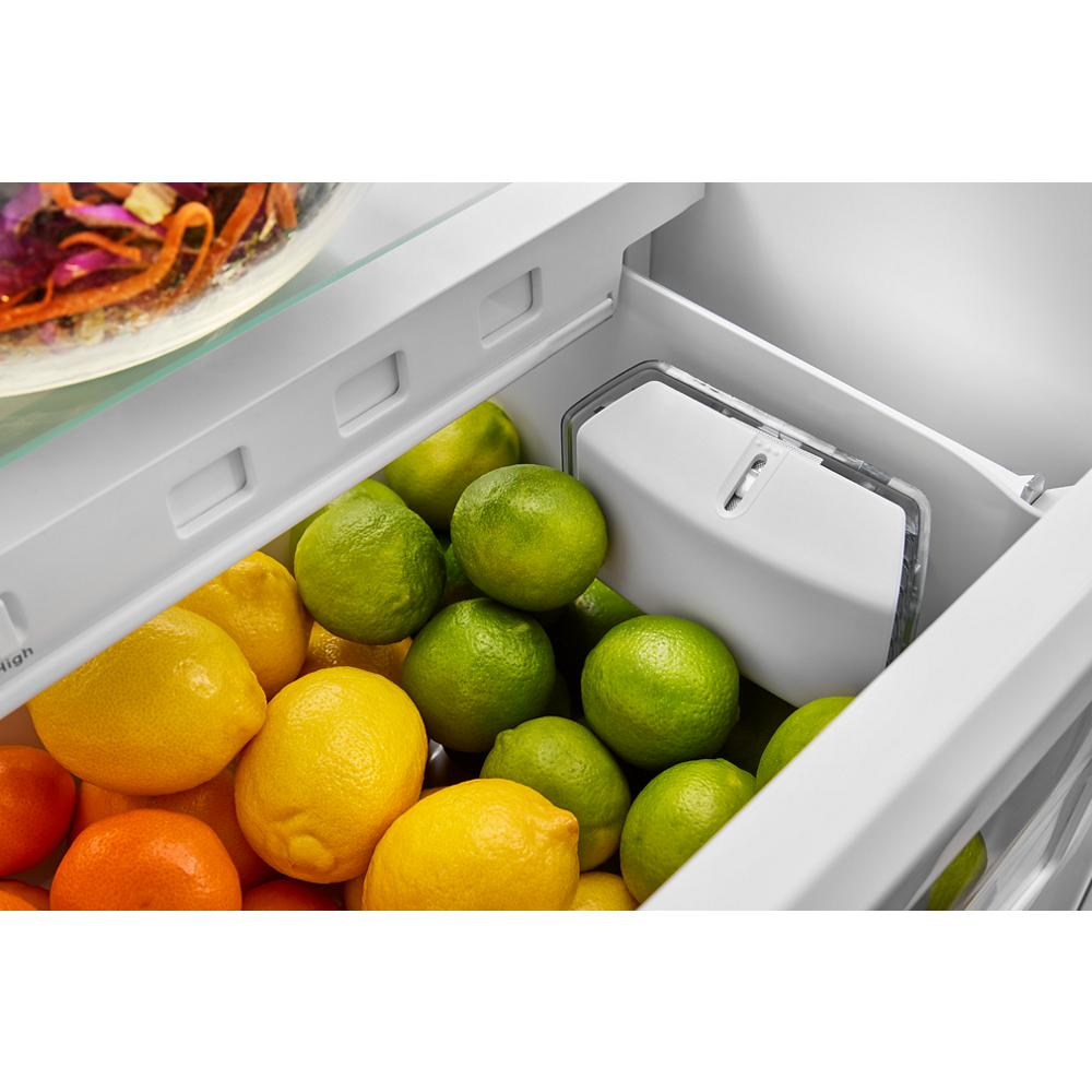 Crisp lemons, limes, and oranges stored inside a refrigerator drawer in KitchenAid French Door Refrigerator collection.