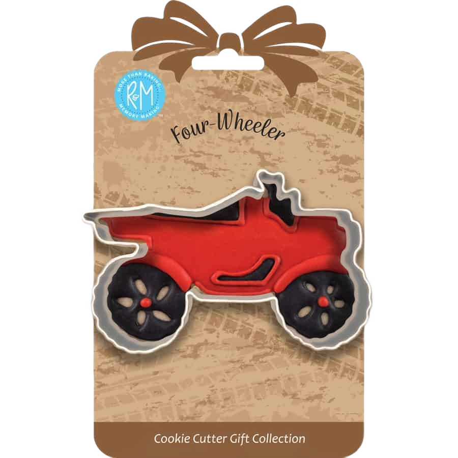 Four wheeler shaped metal cookie cutter displayed on rustic gift packaging for baking projects