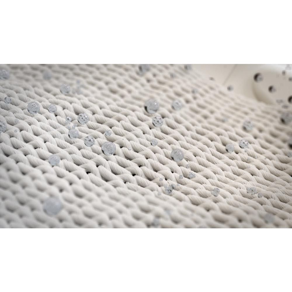 Close-up of woven fabric texture with water droplets highlighting the sanitize cycle feature in modern dryers collection.