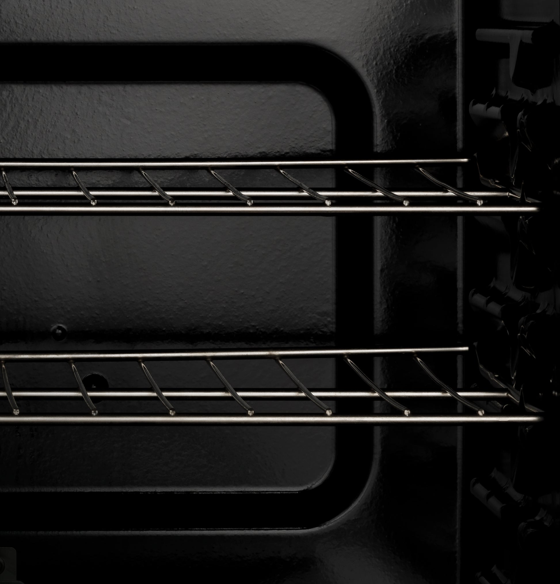 Interior view of empty oven with two metal racks in a free-standing electric range from kitchen appliances collection