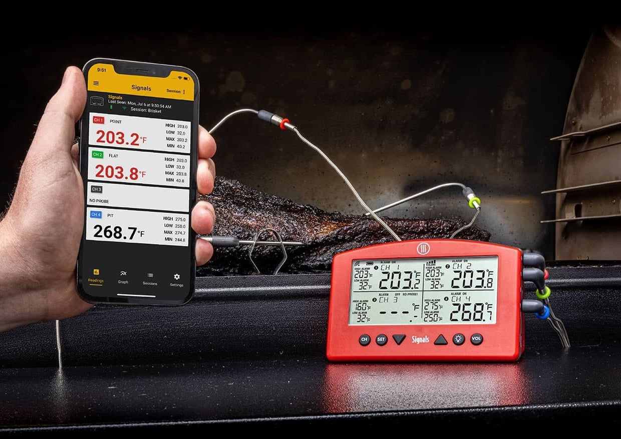 Red alarm thermometer with four temperature probes displayed alongside smartphone app in grilling tools and outdoor living collections