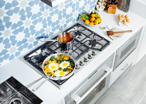 30-inch stainless steel gas cooktop with five burners and control knobs from Thermador kitchen appliances collection