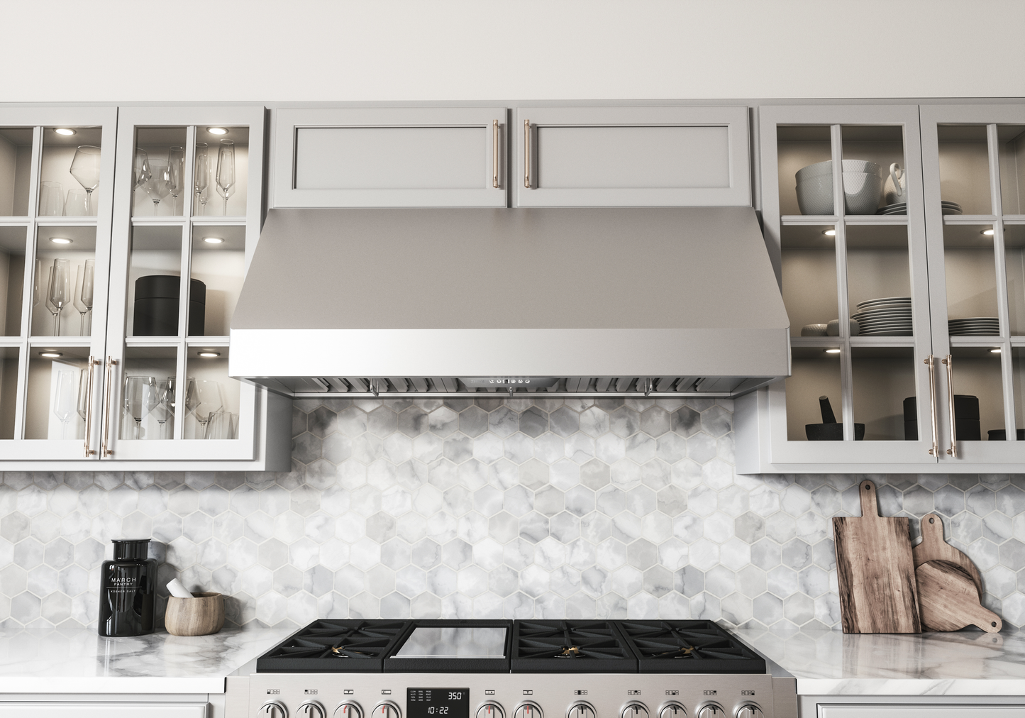 Stainless steel wall-mounted range hood with LED lighting and pro baffle filters installed above a gas cooktop in a contemporary kitchen with light gray cabinetry, part of Wall Mounted Range Hoods, Range Hoods, Kitchen & Kitchenware, All Products, and Appliances collections for home improvement.