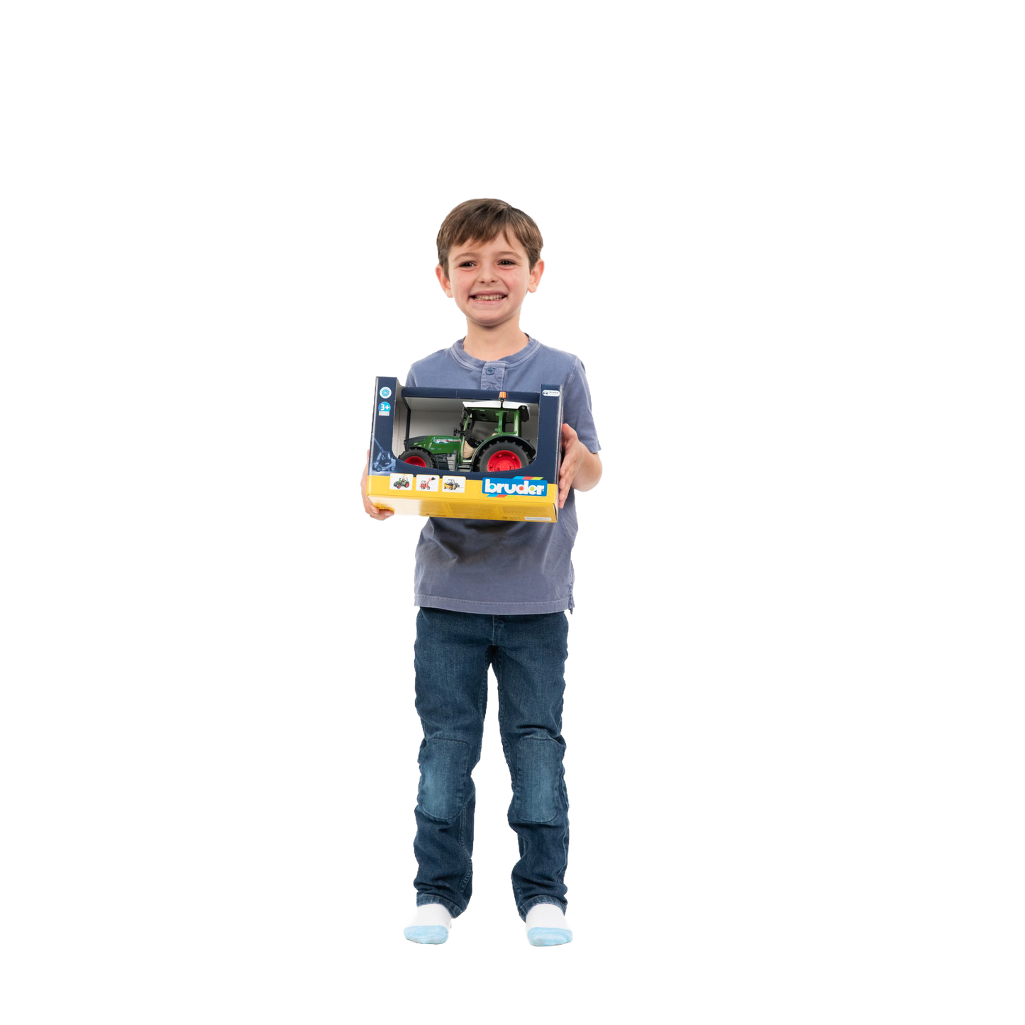 Smiling child holding boxed Bruder Fendt Vario 211 Tractor toy from Vehicles & Remote Controlled Toys collection under $100