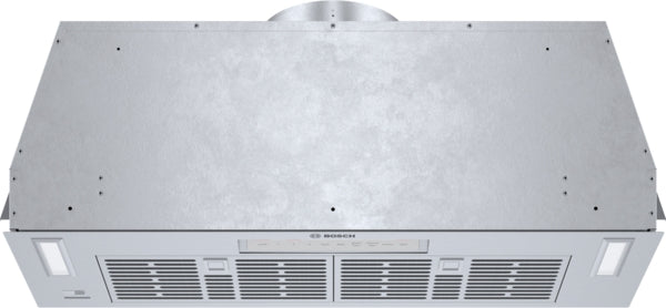 Stainless steel custom insert range hood with mesh filters and integrated lighting for kitchen ventilation systems
