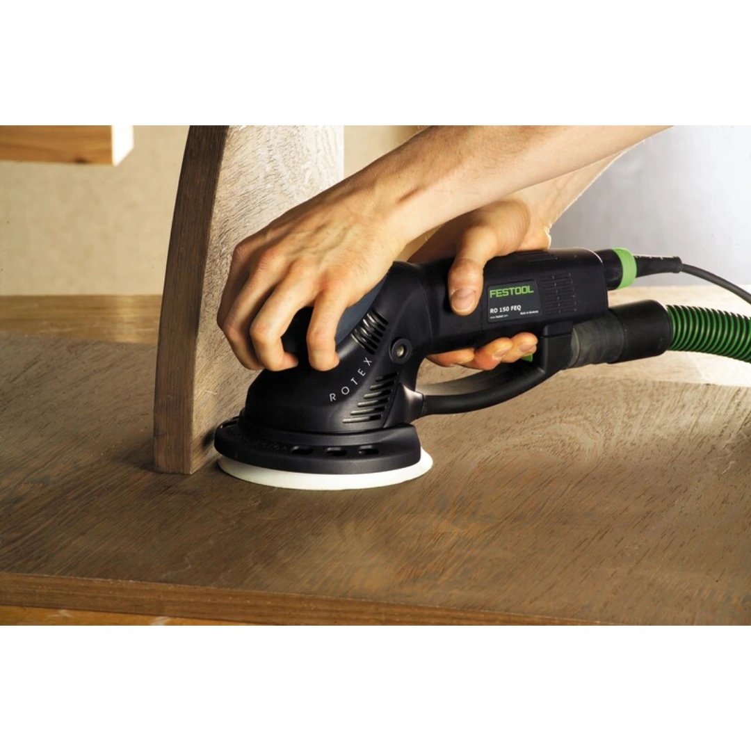 Person using a Festool RO 150 sander on wooden furniture with dust extraction in woodworking tool accessories collection