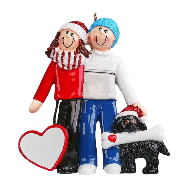 Joyful couple in winter attire with black dog holding a bone and heart for Christmas tree decoration under 50 collection