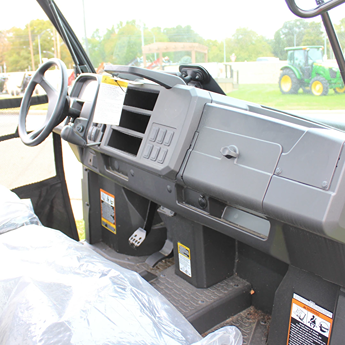 Interior view of a full-size utility vehicle featuring durable dashboard and spacious legroom for outdoor tasks